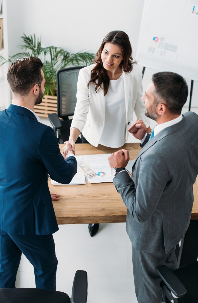 beautiful-advisor-and-handsome-investor-shaking-hands-at-workplace.jpg